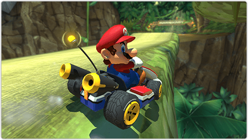 Mario drives his kart dangerously close to the edge but stays on the track.
